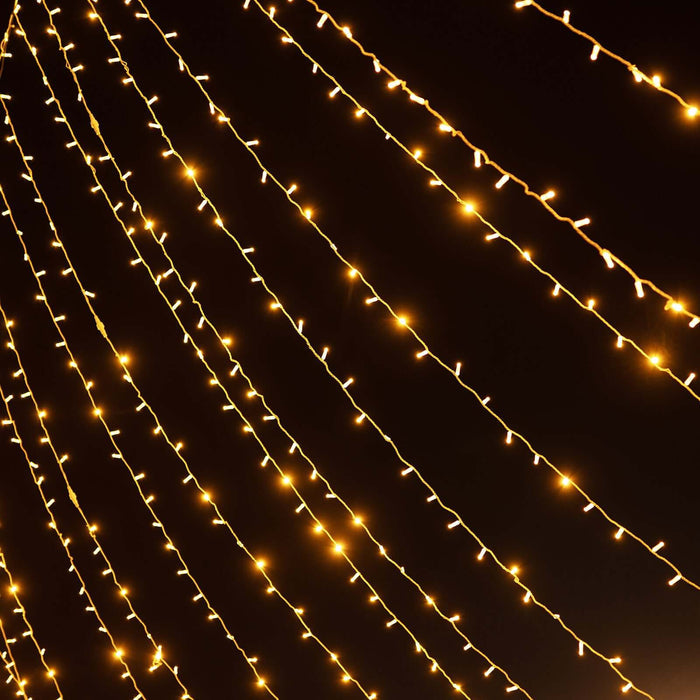 String of warm white fairy lights glowing in the dark.