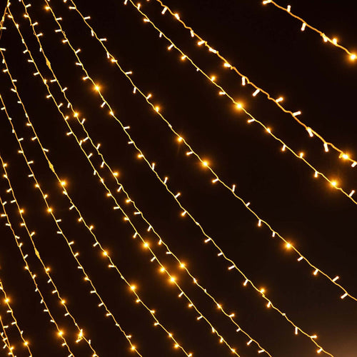 String of warm white fairy lights glowing in the dark.