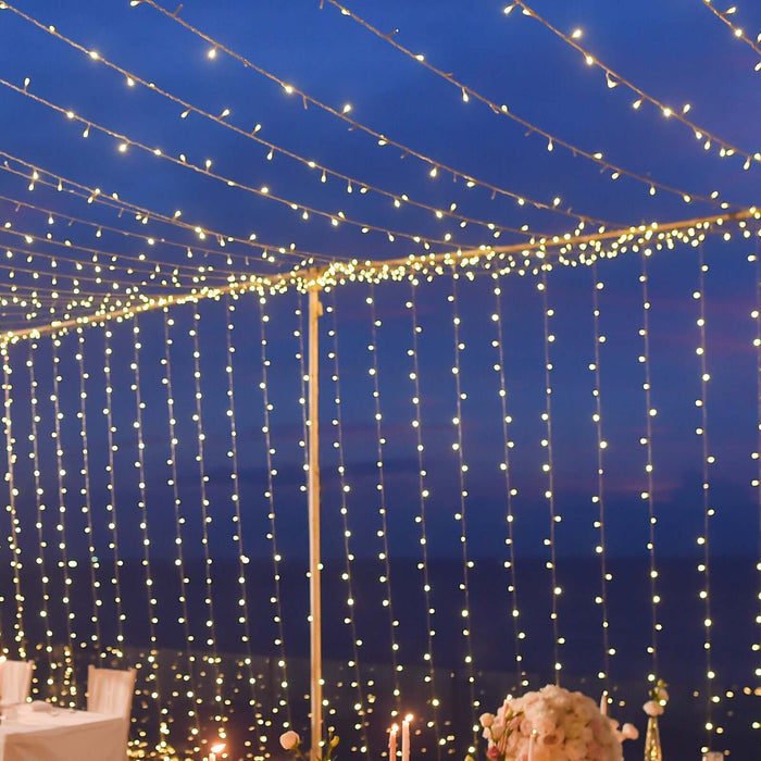 Decorative string lights hanging at an outdoor evening event.