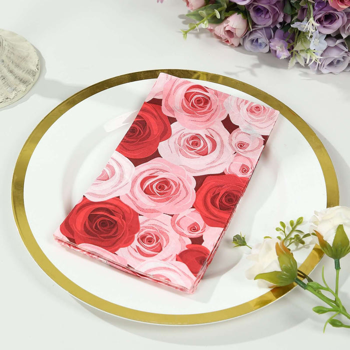 Rose-patterned napkin on a gold-rimmed plate with floral decor.