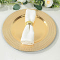Elegant gold charger plate with a white napkin and decorative ring.