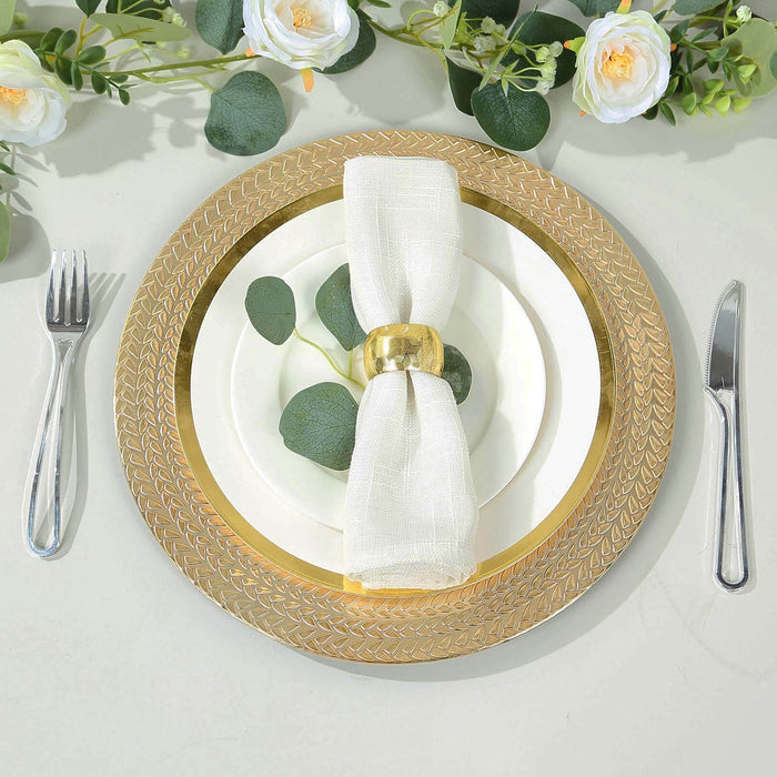 Elegant table setting with gold charger, white plates, and floral accents.