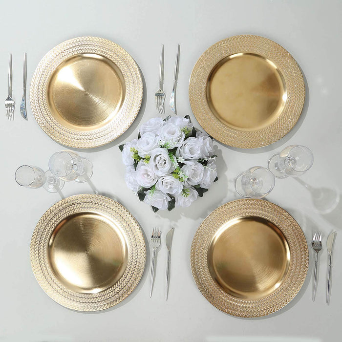 Elegant gold chargers with floral centerpiece on a white table setting.