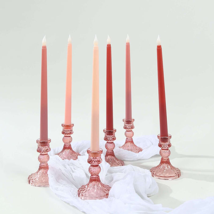 Pink glass candle holders with colorful taper candles