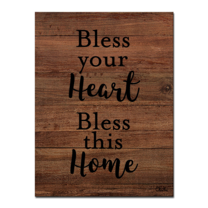 Cream script reading Bless Your Heart Bless This Home on dark walnut wood.