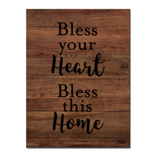 Cream script reading Bless Your Heart Bless This Home on dark walnut wood.