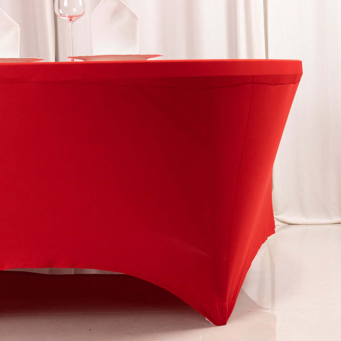 Red table cover fitting a rectangular table in a studio setting.