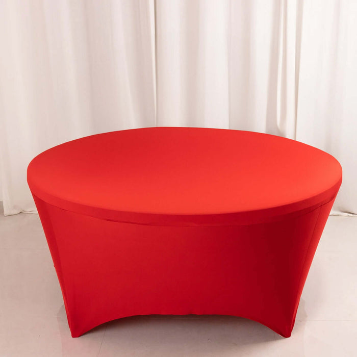 Red oval table with fitted cover on a plain backdrop